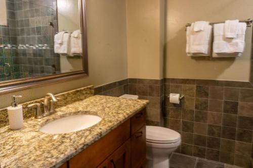 a bathroom with a sink and a toilet and a mirror at Tamarron Lodge Loft 511 in Durango