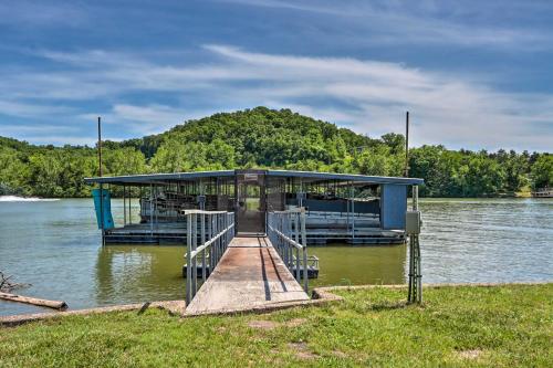 a dock in the middle of a body of water at Dragon Castle with Secret Passage, Dock, and Hot Tub in Camdenton