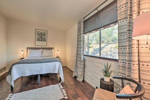 Un dormitorio con una cama y una ventana grande. en Tucson Oasis La Casa de las Palmas with Pool!, en Tucson