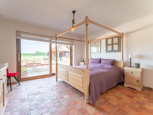 a bedroom with a bed and a large window at Villa Noortem in Maldegem