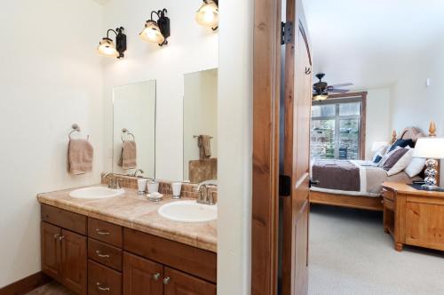 a bathroom with two sinks and a large mirror at Peregrine Point 205 in Durango Mountain Resort