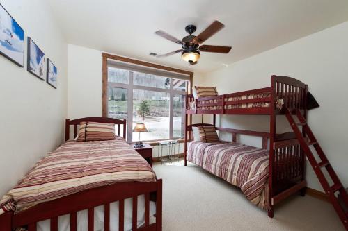 a bedroom with two bunk beds and a ceiling fan at Peregrine Point 205 in Durango Mountain Resort