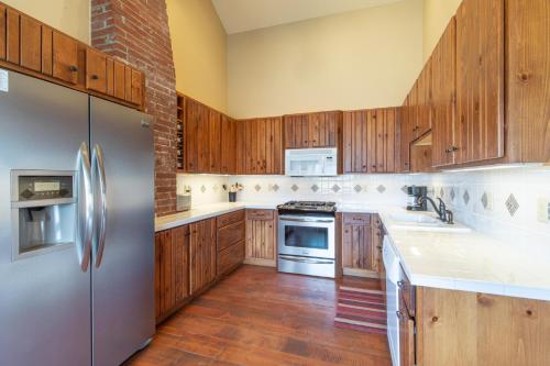 a kitchen with wooden cabinets and stainless steel appliances at Meadow View Cabin in Creede