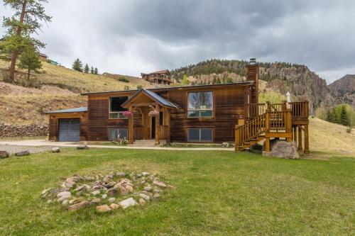 a log cabin in the mountains with a yard at Aspen Grove in Creede