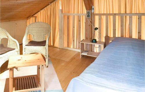 a bedroom with a bed and chairs in a cabin at Gorgeous Home In Schwarz With Kitchen in Schwarz