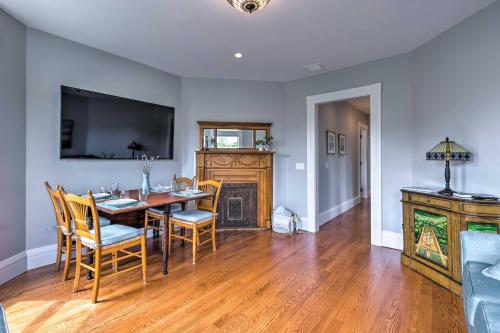 a dining room with a table and chairs and a television at Charming Greenport Gem 1, 1 Mile to Ferry! in Greenport