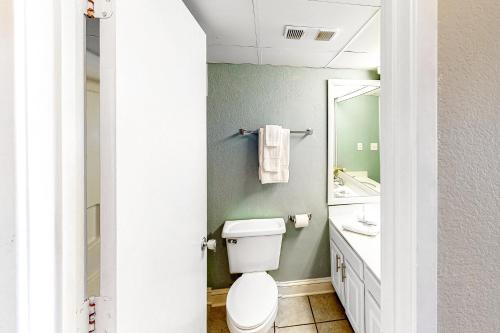 a bathroom with a toilet and a sink and a mirror at Driftwood 51009 in Myrtle Beach