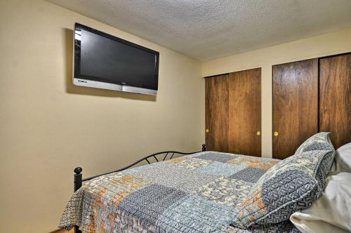 a bedroom with a bed and a flat screen tv on the wall at Portland Haven Next to St Vincents Hospital in Portland
