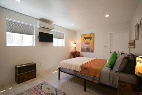 a bedroom with a bed and a flat screen tv at Casa Vitalia in Santa Fe