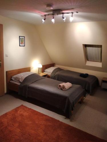 a bedroom with two beds and a room with a ceiling at Haus Engelskrug in Senheim