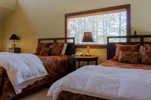 a bedroom with two beds and a window at Tamarron PineCone 858 in Durango