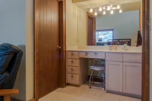 a bathroom with a sink and a vanity with a mirror at Tamarron PineCone 858 in Durango