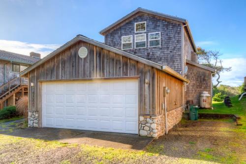 a garage with a white garage door in front of a house at Twin Rocks Haven in Rockaway Beach