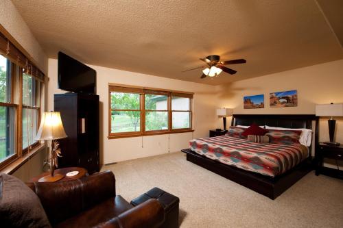a bedroom with a bed and a ceiling fan at 210 Cypress Court in Hermosa