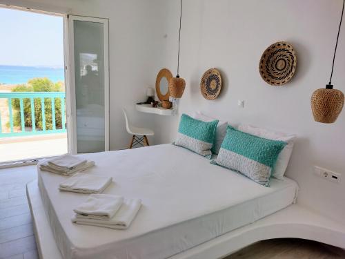 a bedroom with a bed with a view of the ocean at Elysium Beachfront Residences by kalais - A 10 Minute Drive Away From Naxos Town in Plaka