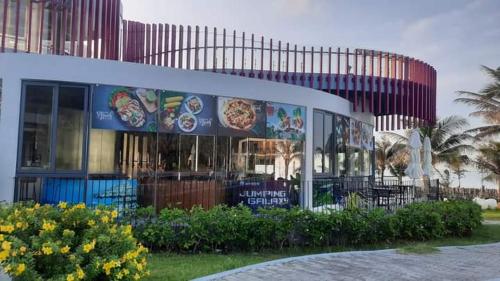 a building with signs on the side of it at Oceanami Resort & Beach Club in Long Hai