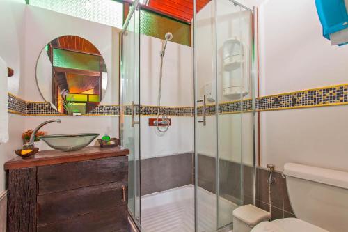 a bathroom with a shower, toilet, and sink at Panvaree Resort in Ban Chieo Ko