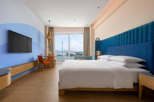 Postel nebo postele na pokoji v ubytování Hyatt Regency Hainan Ocean Paradise Resort