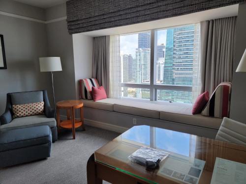 a living room with a couch and a large window at Four Seasons Studio - Privately Owned Unit in Miami