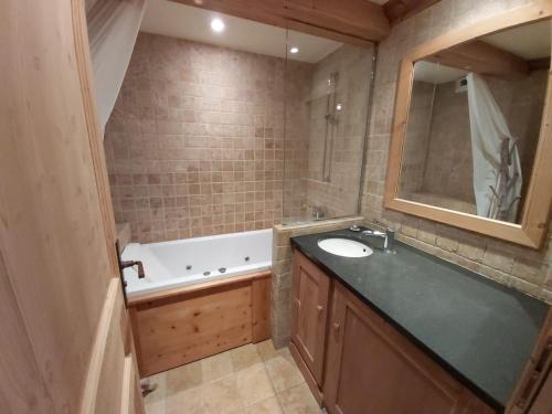 a bathroom with a sink and a bath tub at Appartement Val-d'Isère, 2 pièces, 4 personnes - FR-1-518-100 in Val-d'Isère