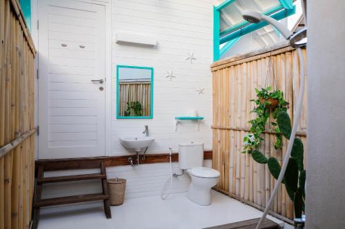 a bathroom with a toilet and a sink at Le Pirate Gili Meno - Adults Only in Gili Meno