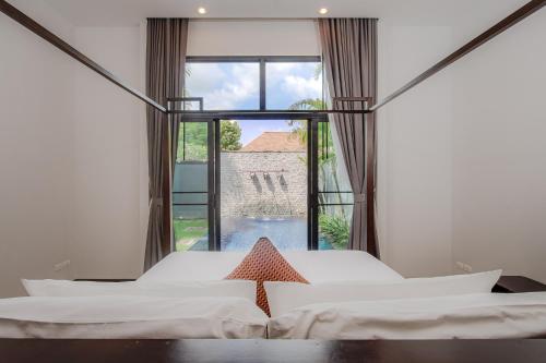a bedroom with two beds and a large window at Villa 1 Bedroom with private pool at ONYX Villa Naiharn in Nai Harn Beach