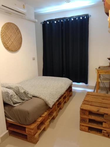 a bedroom with a wooden bed and a window at La Locanda in Bangkok