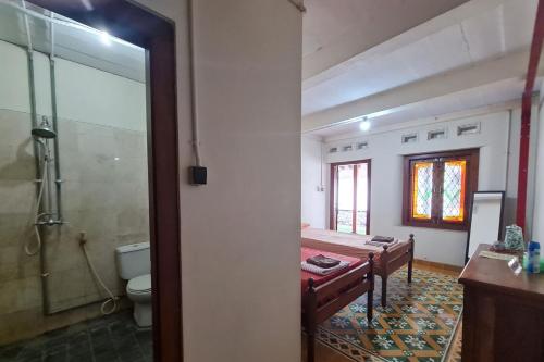 a bathroom with a shower and a sink and a toilet at Omah Pitoe Yogya Homestay in Yogyakarta