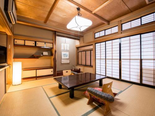 a living room with a table and a couch at Takanosukan in Sekikawa