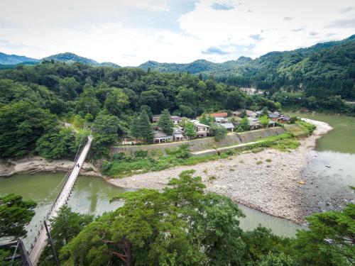 an aerial view of a river with a bridge at Takanosukan in Sekikawa