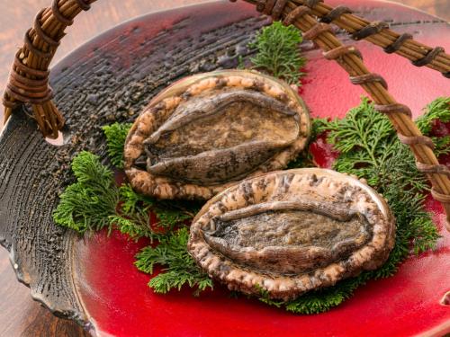 two oysters on a glass plate on a table at Takanosukan in Sekikawa