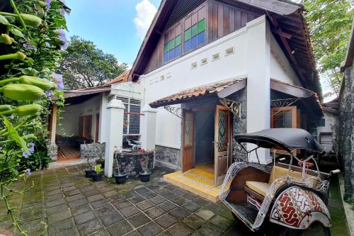 a house with a motorcycle parked in front of it at Omah Pitoe Yogya Homestay in Yogyakarta