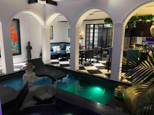 a living room with a swimming pool in a house at Golden Gorilla Villa with private pool & jacuzzi in Angeles