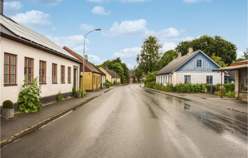 an empty street in a small town with houses at 4 Bedroom Cozy Home In Smedstorp in Smedstorp