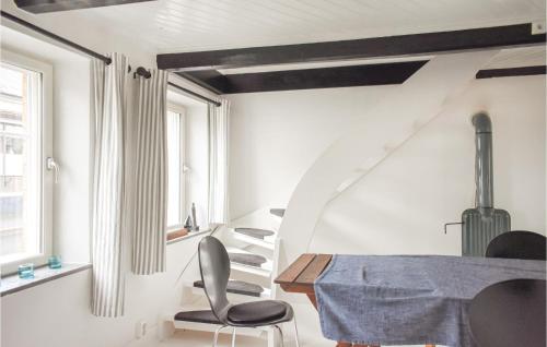 a room with a staircase and a table and chairs at 4 Bedroom Cozy Home In Smedstorp in Smedstorp