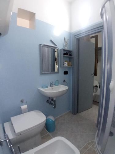 a bathroom with a white toilet and a sink at Ely Sea in Belvedere Marittimo
