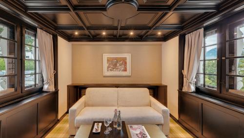 a living room with a couch and a table at Morosani Schweizerhof in Davos