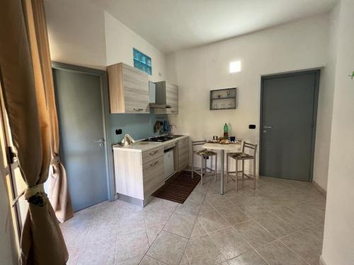 a kitchen with a sink and a table in it at Ely Sea in Belvedere Marittimo