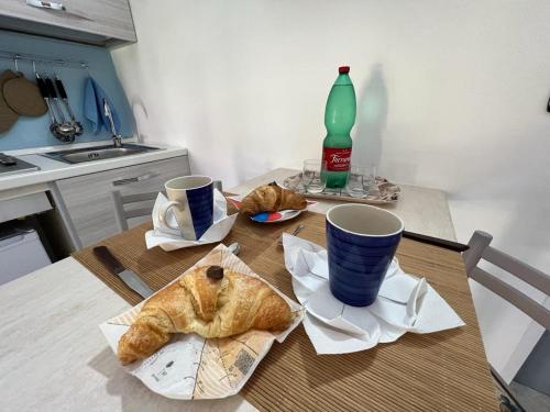 a table with two cups and croissants on it at Ely Sea in Belvedere Marittimo
