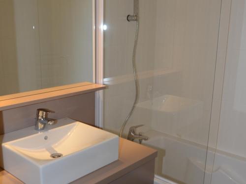 a white bathroom with a sink and a shower at Appartement Flaine, 2 pièces, 4 personnes - FR-1-425-189 in Flaine