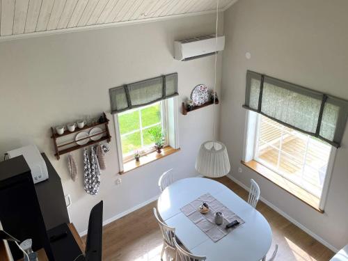 a dining room with a table and two windows at 6 person holiday home in GÖTENE-By Traum in Götene
