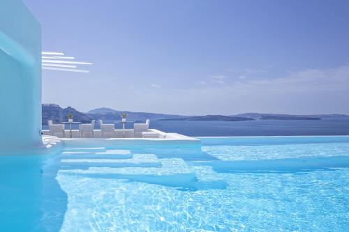 a large body of water with a blue sky at Canaves Oia Boutique Hotel in Oia