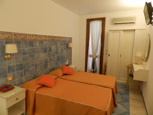 a hotel room with a bed, table, and window at Hotel Punta Mesco in Monterosso al Mare