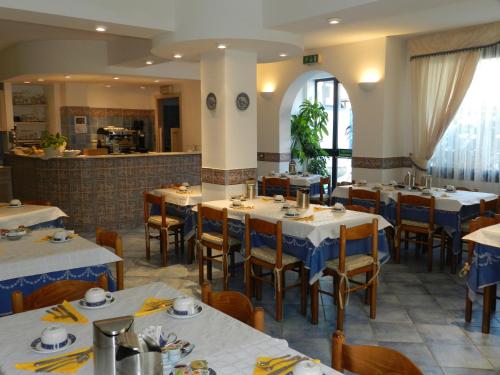 a restaurant with tables and chairs and a counter at Hotel Punta Mesco in Monterosso al Mare