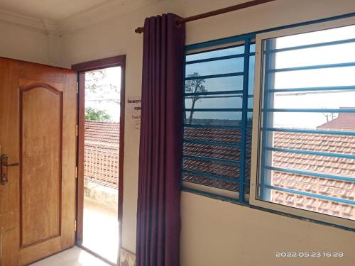 an empty room with a door and a window at Silver Dolphin Guesthouse & Restaurant in Kratie