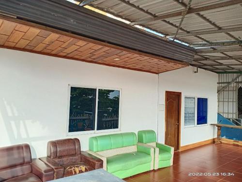 a living room with a couch and two chairs at Silver Dolphin Guesthouse & Restaurant in Kratie