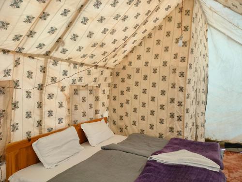 a bedroom with two beds in a tent at Neryok's Indus view in Chimre