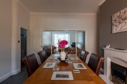 a dining room with a table and a fireplace at The Old Nags Head in Bishop Auckland
