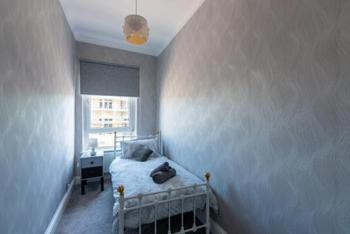 a small bedroom with a bed and a window at The Old Nags Head in Bishop Auckland