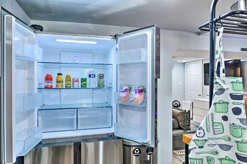 an empty refrigerator with its door open in a kitchen at Stylish DC Studio about 5 Mi to National Mall! in Washington